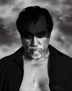 I Serve in Shadows I Serve in Shadows - Grayscale photograph of bust of male figure, top half of face in darkness.